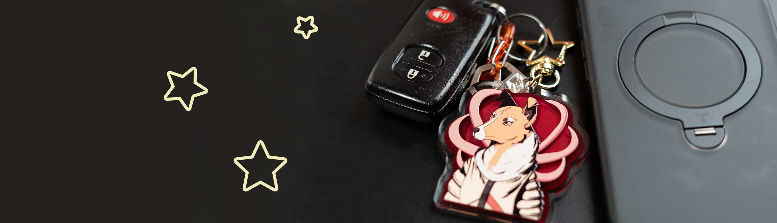 Keychain with Laika the space dog on it and car keys and a phone