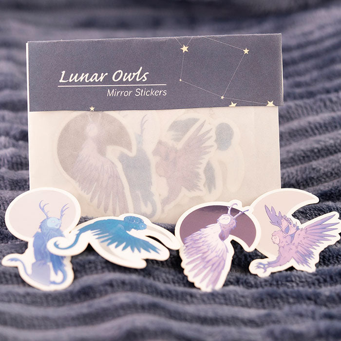 mirror lunar owl stickers laid out with packaging